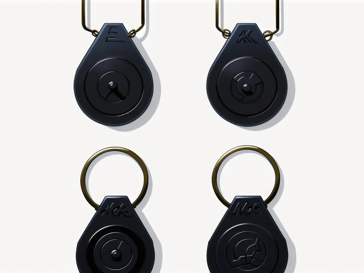 Quadrilateral arrangement of four black keychain loops, each fitted with a round cavity to accommodate a tracking gadget. Arrangement of Four Square Black Keychain Loops, Each Equipped with a Round Hole for Fitting a Tracking Device