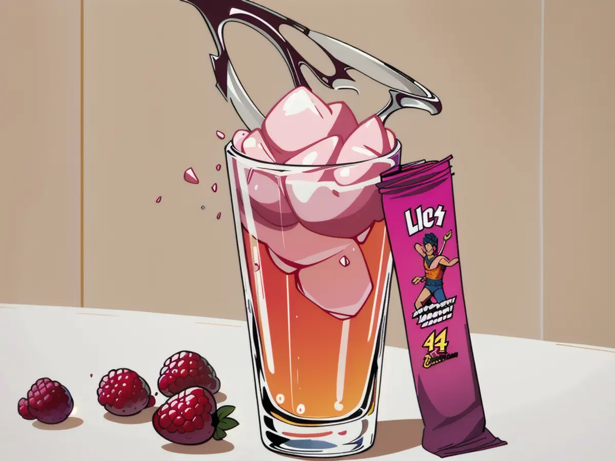 Beverage with a rosy hue, served over ice, adorned by raspberries and a pomegranate. A berry-flavored healing drink mix packet lies nearby. Beverage in a pink hue, served over ice and accompanied by raspberries and a pomegranate. A berry-flavored